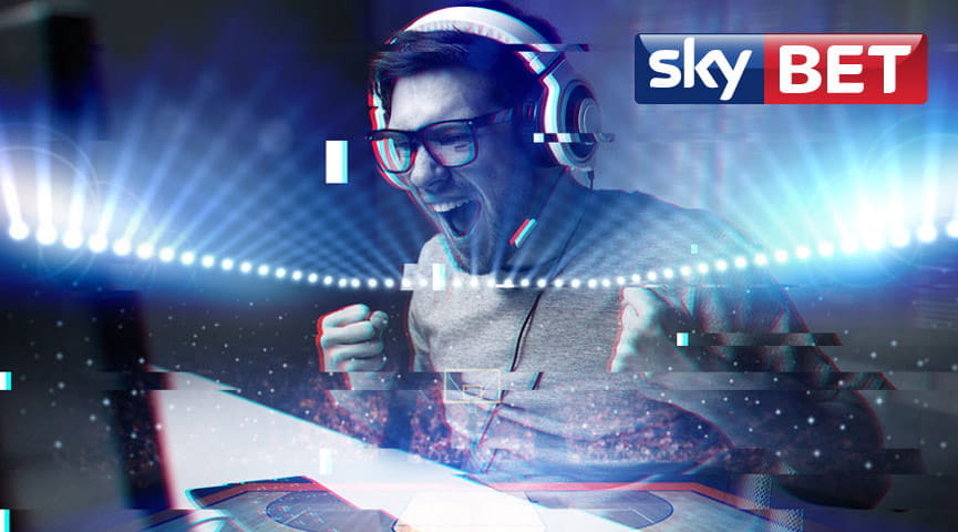 Il logo di Sky Bet e un ragazzo che esulta davanti a un computer, con un palazzetto dello sport affollato sullo sfondo